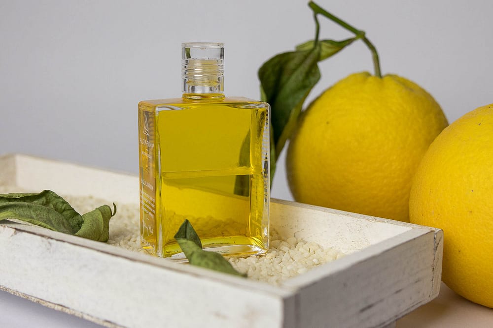 Produktfoto einer AURA-SOMA Equilibrium Flasche in der Farbe Gelb mit zwei Zitronen im Hintergrund